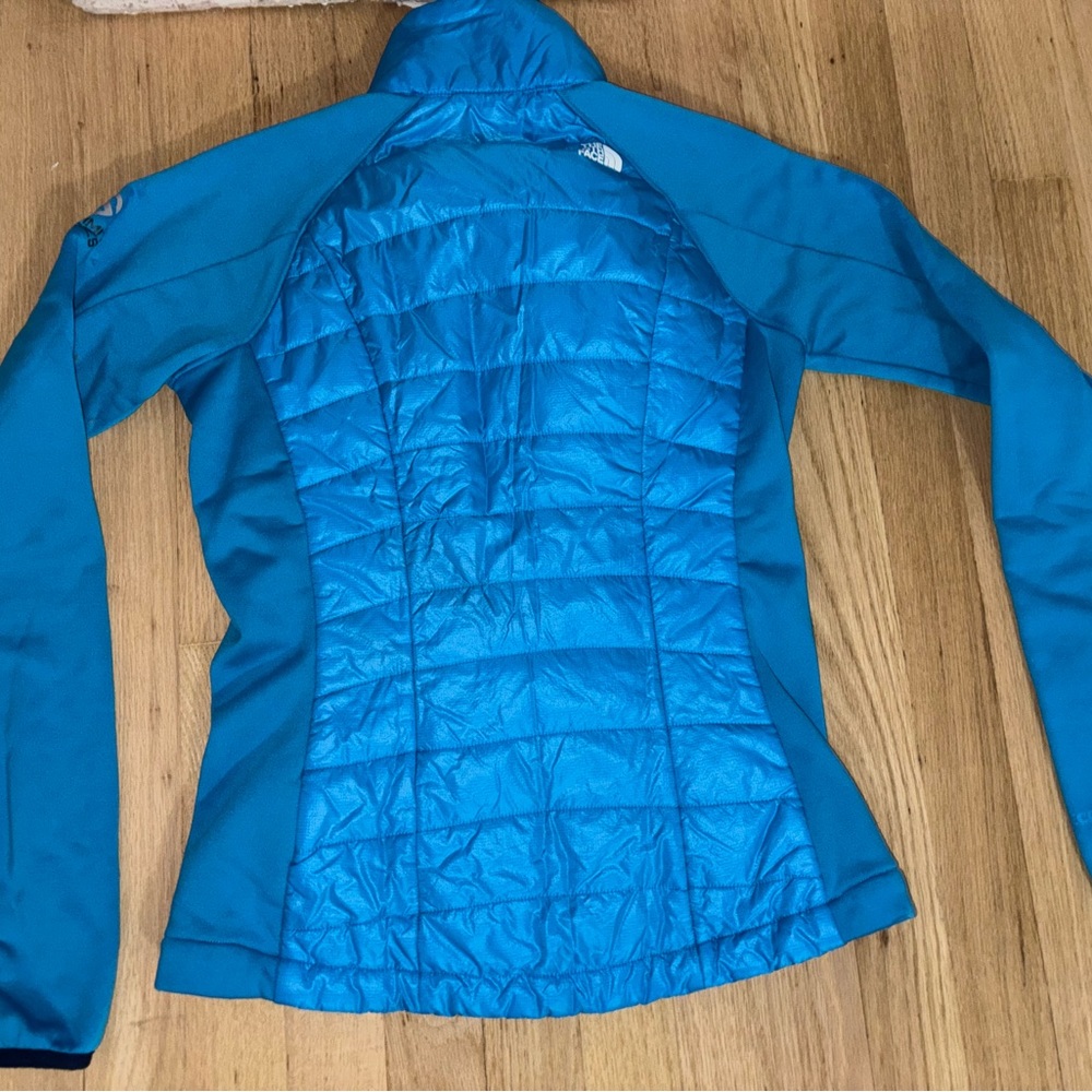 Blue puffer coat with thin sleeves. Very comfy & great for layering with skiing